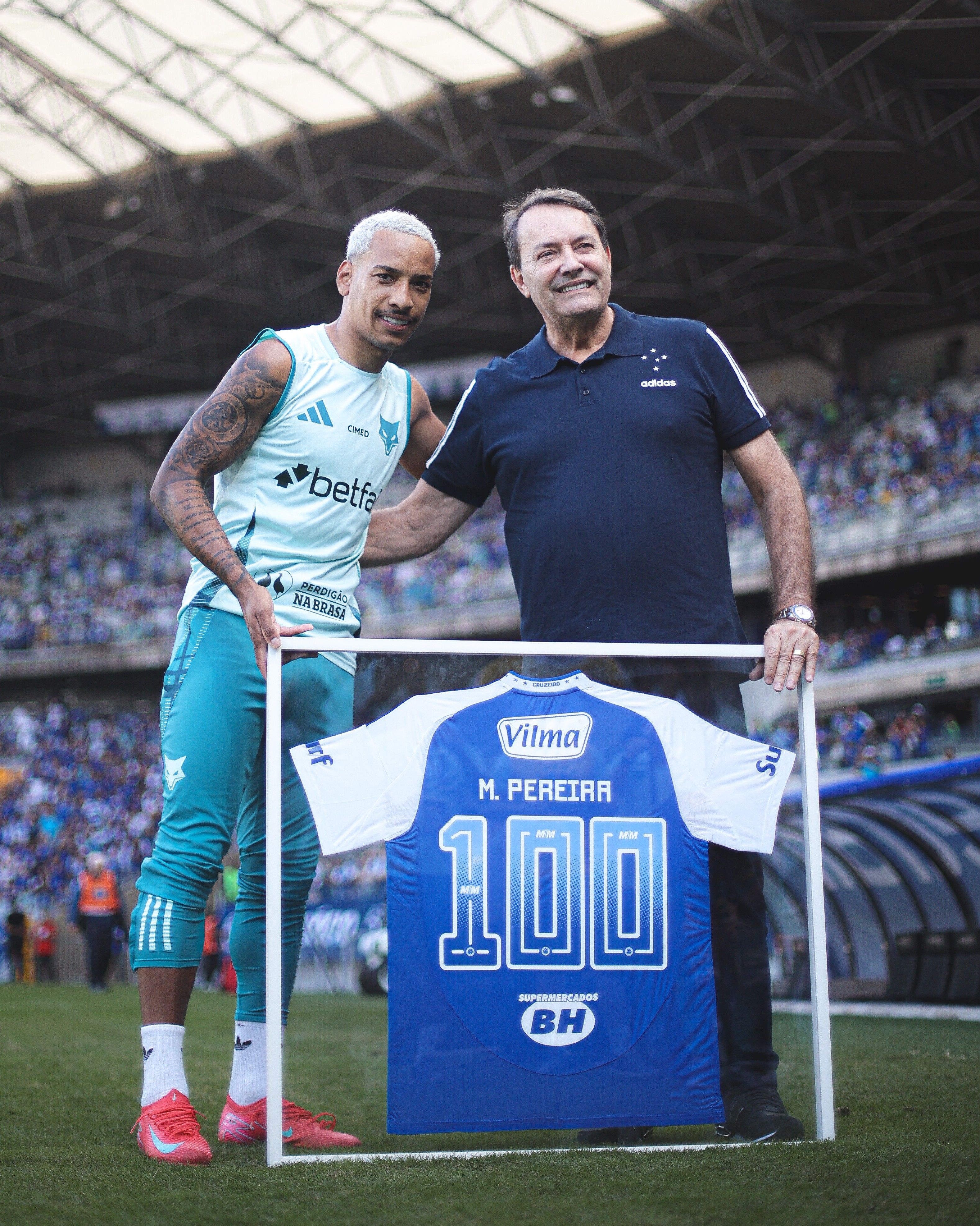 Matheus Pereira celebra 100 jogos pelo Cruzeiro com placa de homenagem.