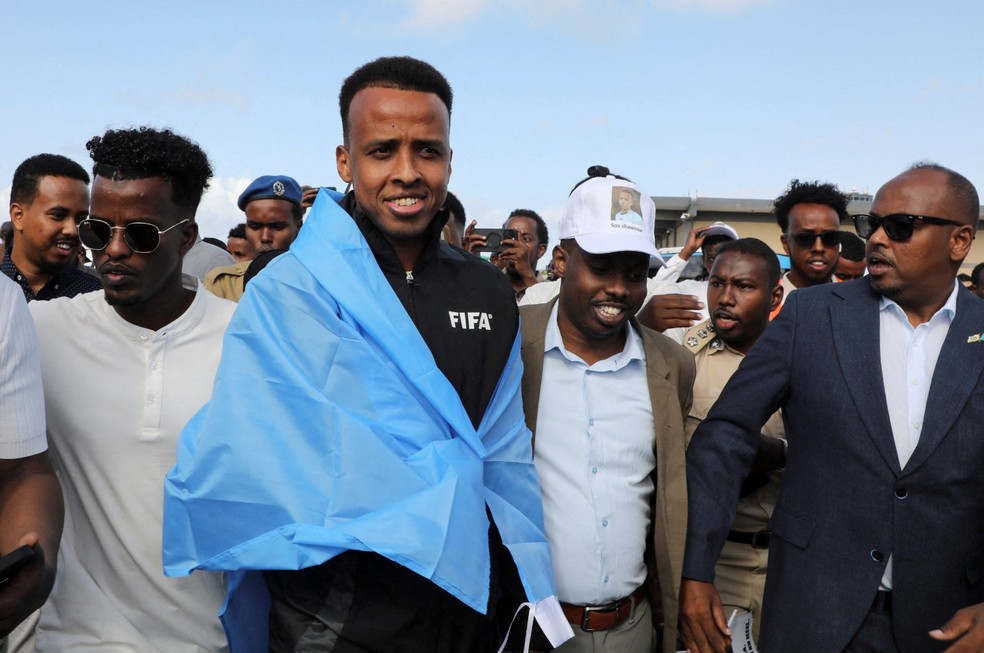 Árbitro barrado nos EUA Omar Abdulkadir Artan cumprimentando apoiadores na chegada à Somália