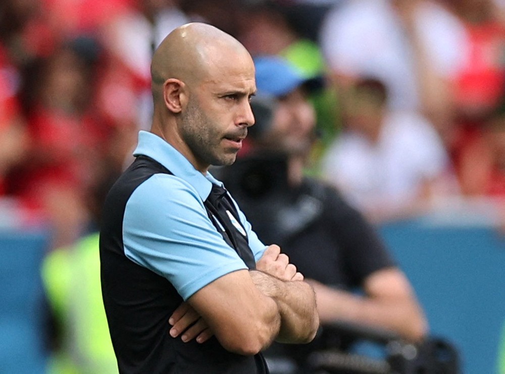 Mascherano é branco, careca e está de camisa preta e azul