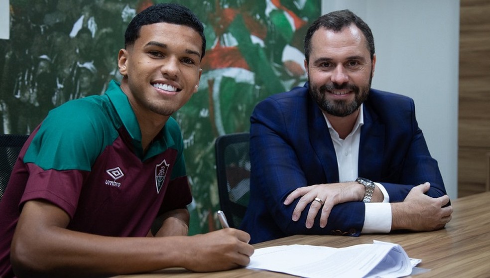 Riquelme Felipe assina contrato ao lado do presidente Mário Bittencourt — Foto: Marcelo Gonçalves / Fluminense FC