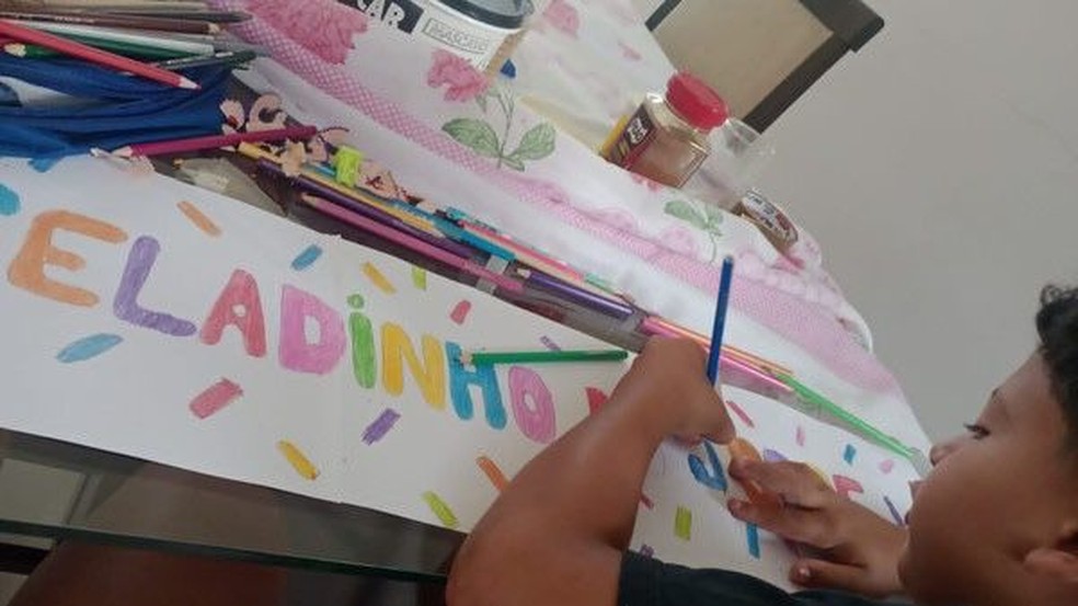 Jorge Henrique desenhando o cartaz para vender geladinho — Foto: Arquivo pessoal