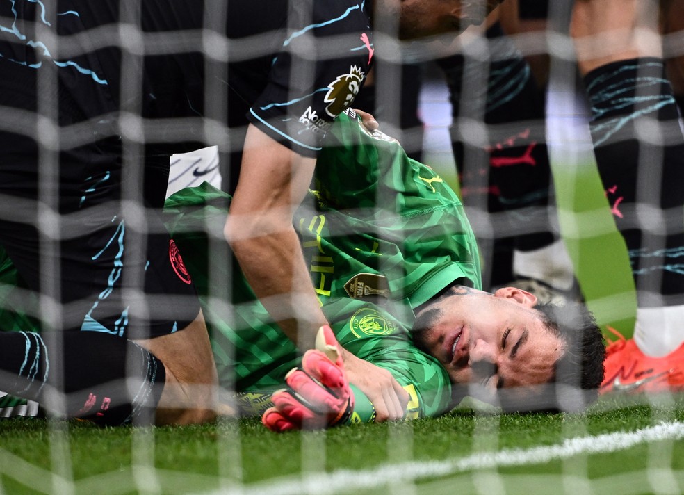 Ederson cai no gramado após choque com Cuti Romero em Tottenham x Manchester City: goleiro foi cortado da Copa América — Foto: Dylan Martínez/Reuters